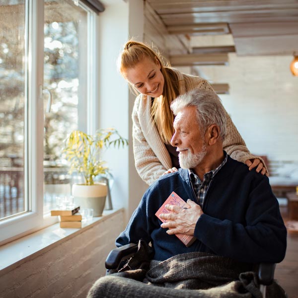 Senior Living Care Giver Woman helping old man in wheelchair in Texas and California